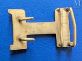 a gold buckle on a blue leather surface