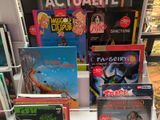 many children ' s books on a shelf in a store