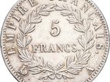 a close up of a coin with a wreath on it