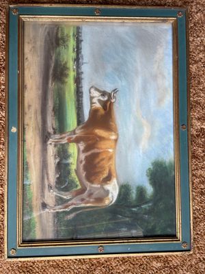 a painting of a bull that is hanging on the wall