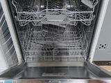 a person holding a dishwasher in their hand