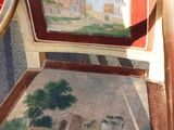 a chair with a painting on the back of it