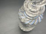 a clear glass bottle with a spiral design on it