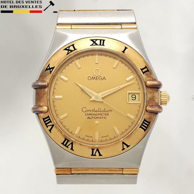 a gold and silver watch with roman numerals on it