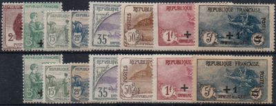 four different stamps of different colors and sizes on a black surface