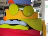 a large stack of colorful kitchen utensils stacked on top of each other