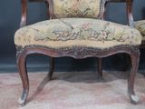 a chair that has a floral upholstered seat on it