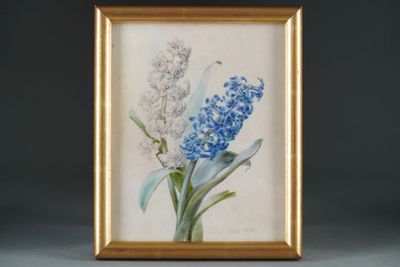 painting of blue and white flowers in a gold frame on a gray surface