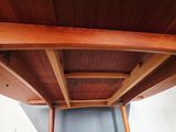 a wooden table with a drawer underneath it