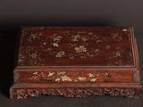 an old wooden box with a floral design on it