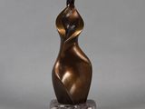 a bronze sculpture of a woman on a marble base
