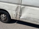 a white van that has been vandalized and is parked in a parking lot