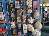many stuffed animals hanging on the wall in the store