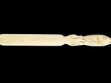 carved wooden spoon with a fish on it on a black background