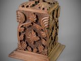 an old wooden box with carvings on it on a gray background