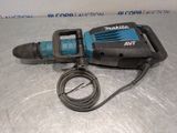 a close up of a drill on a table with a cord