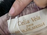 a person holding a label that says celia vela