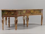 a small wooden table with a painting on it