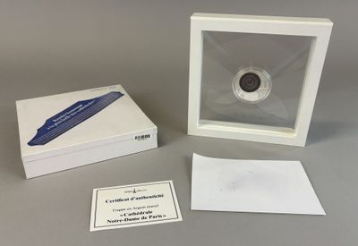 a small white box with a coin inside of it