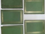 four green trays sitting on a white surface
