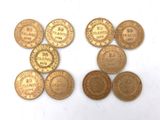 several different types of coins are shown on a white surface