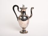 an antique silver plated tea pot with a handle on a white background