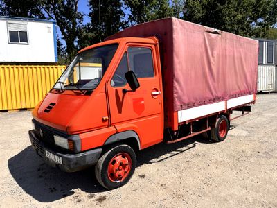 a red truck that is parked in a lot