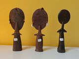 three wooden figurines that are sitting on a table