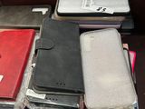many different types of cell phones and wallets on the table