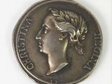 a close up of a coin with a woman ' s head on it