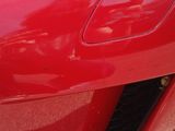 a close up of a red sports car with the hood up