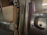 a picture of a room with a sink and a trash can