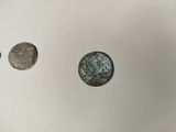 three different types of coins are shown on a white surface