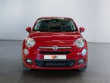 the red car is parked in a large room with a white wall