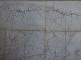 a map on the wall of a building that has a lot of writing on it
