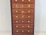 an antique wooden chest of drawers with brass hardware on top