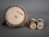 a plate with a picture on it next to salt and pepper shakers