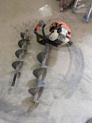 a picture of a man working on a machine in a garage