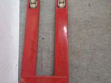 two red tools sitting on the floor next to each other