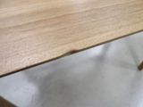 a close up of a wooden table with metal legs