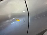 a yellow sticker on the side of a silver car