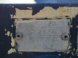 a close up of a rusted metal box in the grass