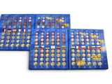 a set of three blue trays filled with different coins