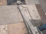 a person standing on the sidewalk with a pair of scissors