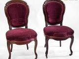 pair of antique chairs with red velvet upholstered on casteors