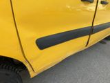 a close up of a yellow car with a black door handle