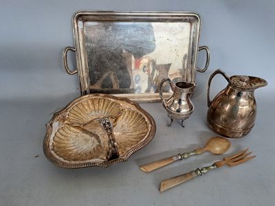 a silver tray with silverware and a mirror on it