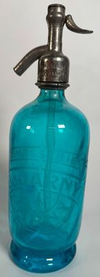 a blue glass bottle with a metal pump on top of it