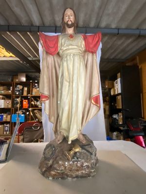 une statue de Jésus debout sur un rocher dans une boutique