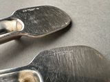 two spatulas that are sitting on a table